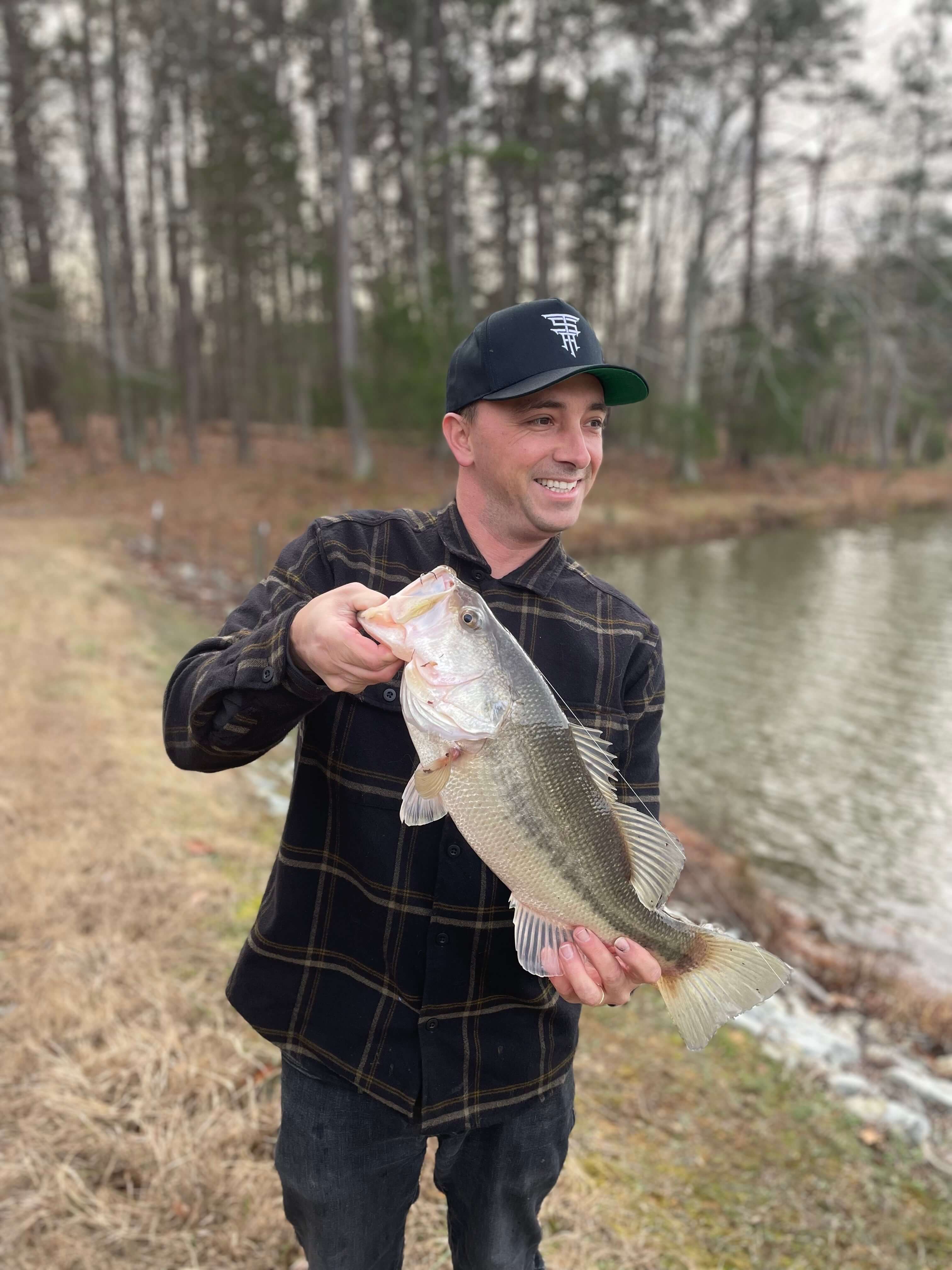 Photo of Target Species Acquired founder, John Prioli. John is smiling and holding a 5 lbs bass.