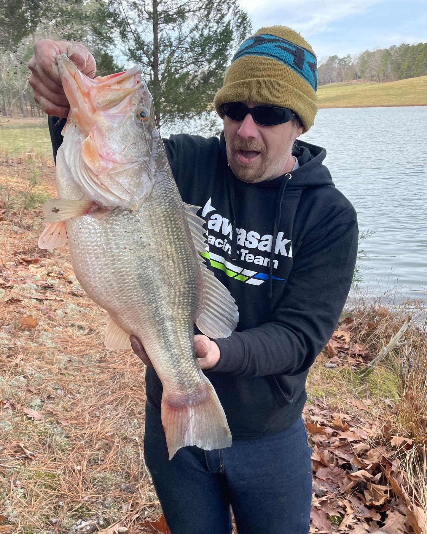 Ian holding a monster 10 lbs bass that he caught using a M450 Lure